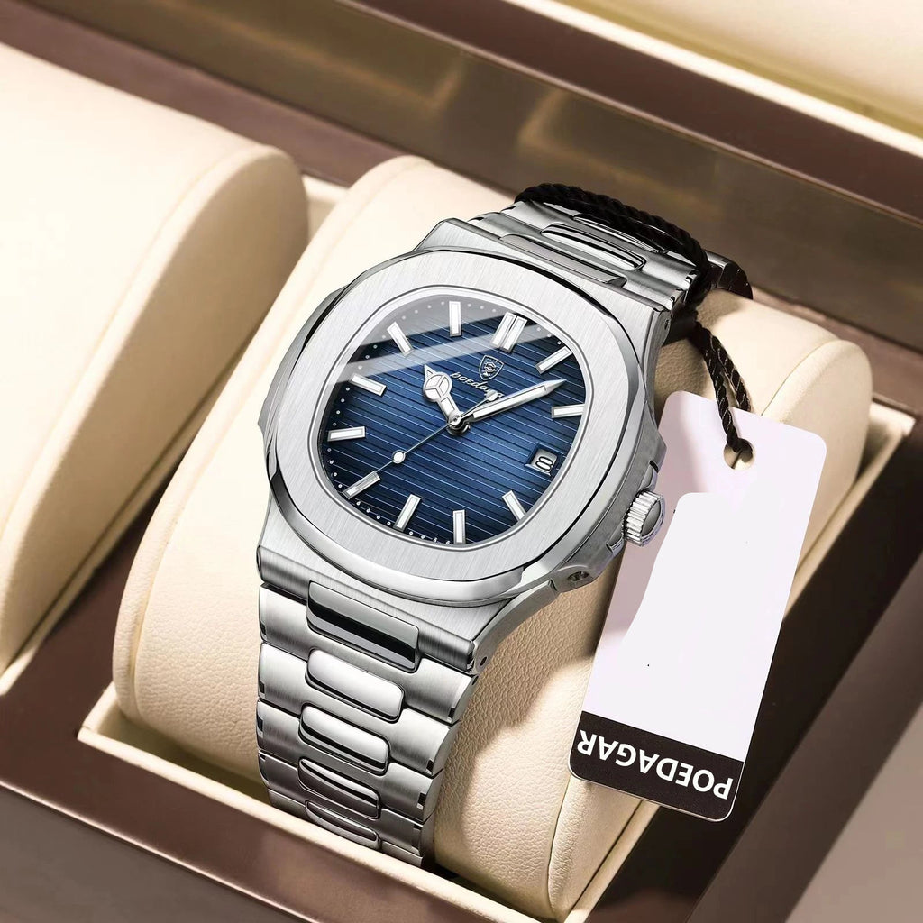 Silver watch with blue face and 'PODAGAR' tag on a beige cushion